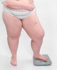 bigstock-Overweight-woman-measuring-wai-25335161